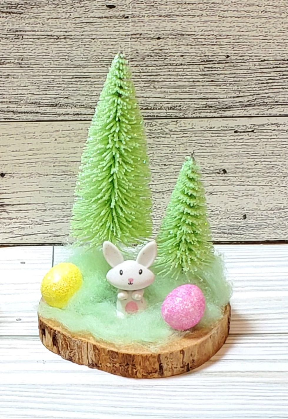 Bunny with trees or carrots on wood round